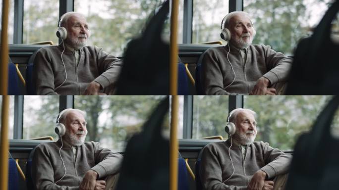 高级男子在公共汽车上用耳机听音乐