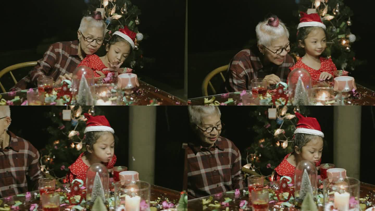 侄女和祖母在圣诞派对上拍照后吹纸屑-库存视频