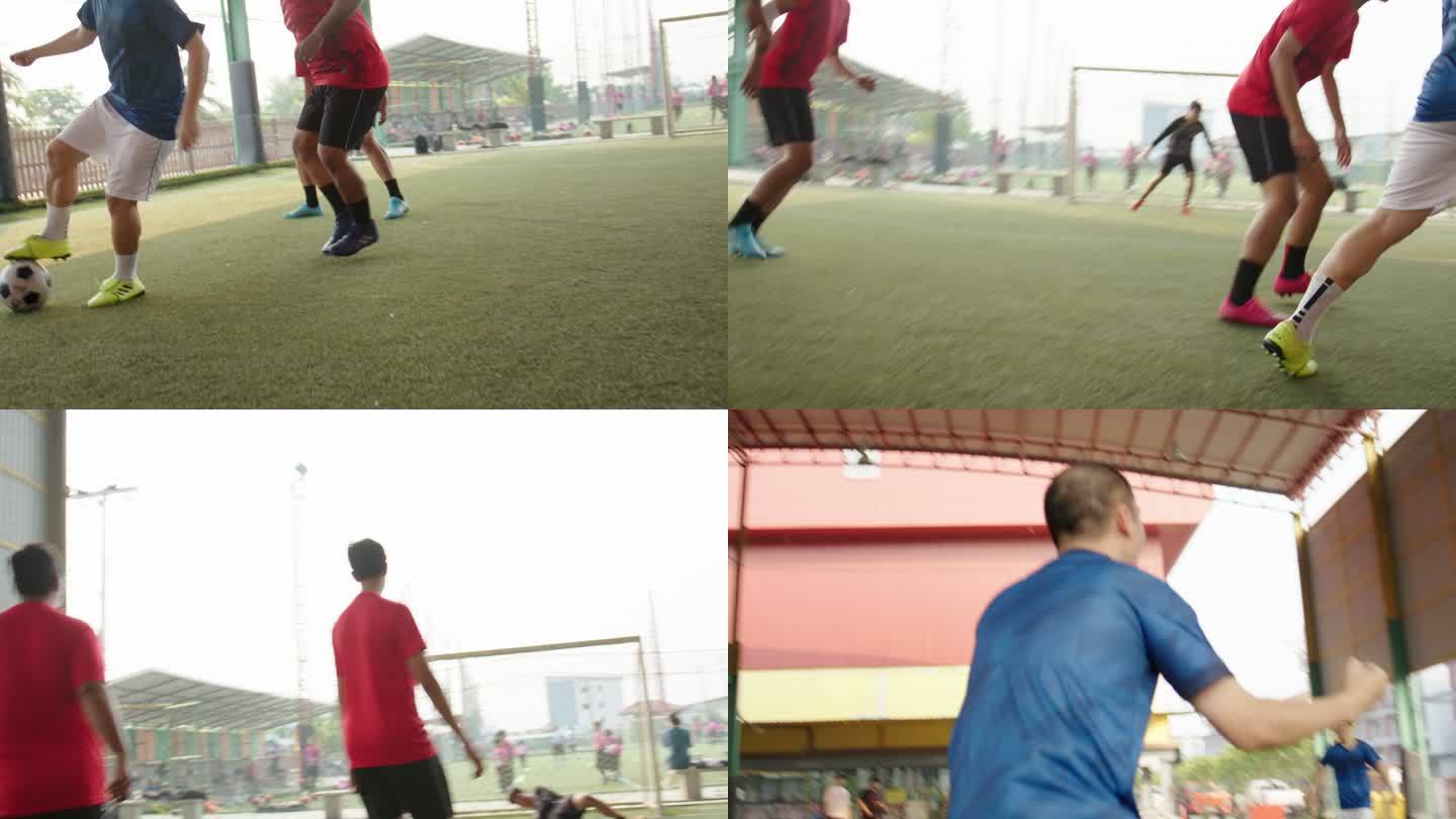亚洲男子足球运动员与朋友打球。