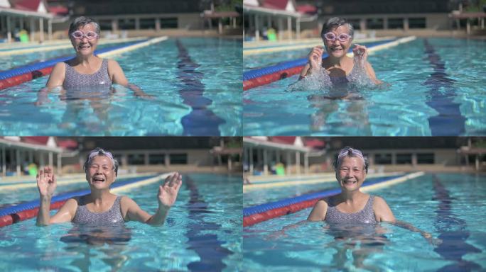 周末早上，一位亚裔中国高级女性在游泳池里看着镜头微笑