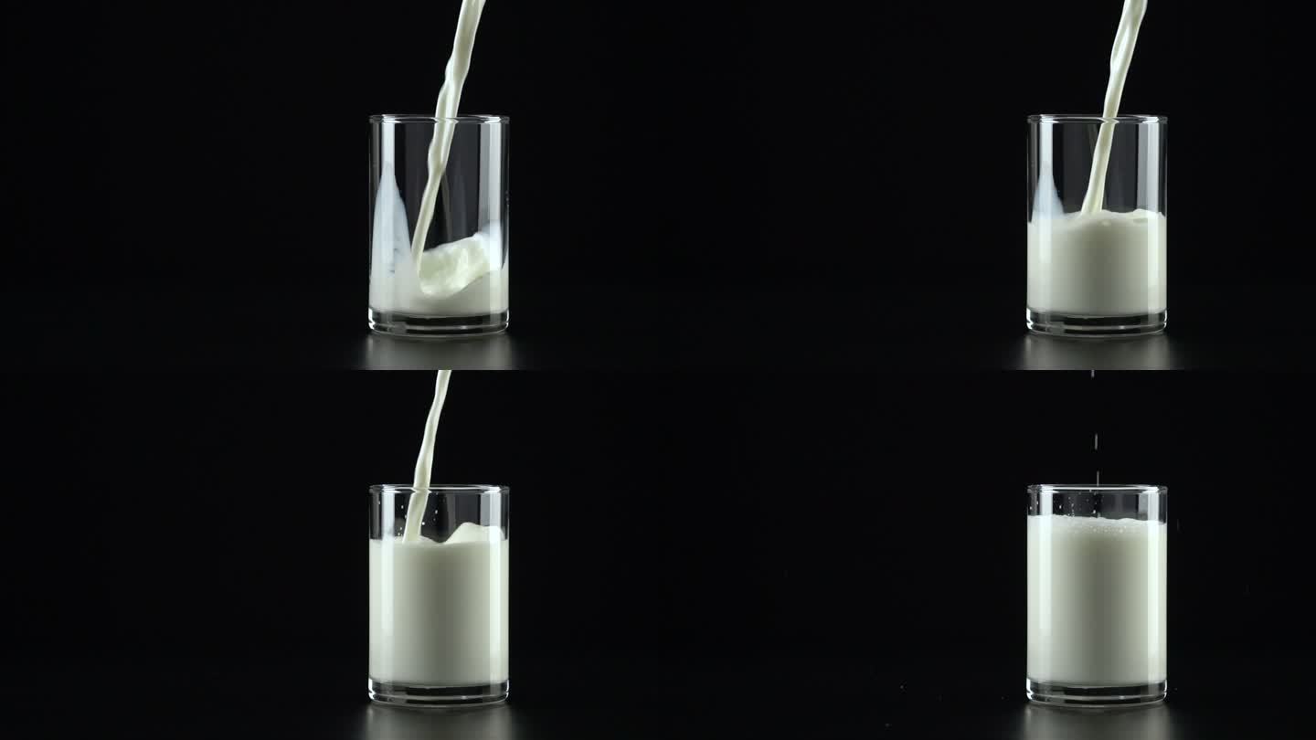 慢动作：将牛奶倒入黑色背景的玻璃杯中。