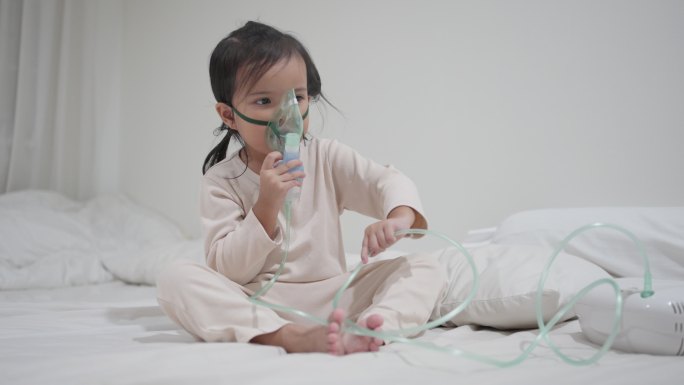 生病的小女孩用吸入器呼吸，雾化治疗