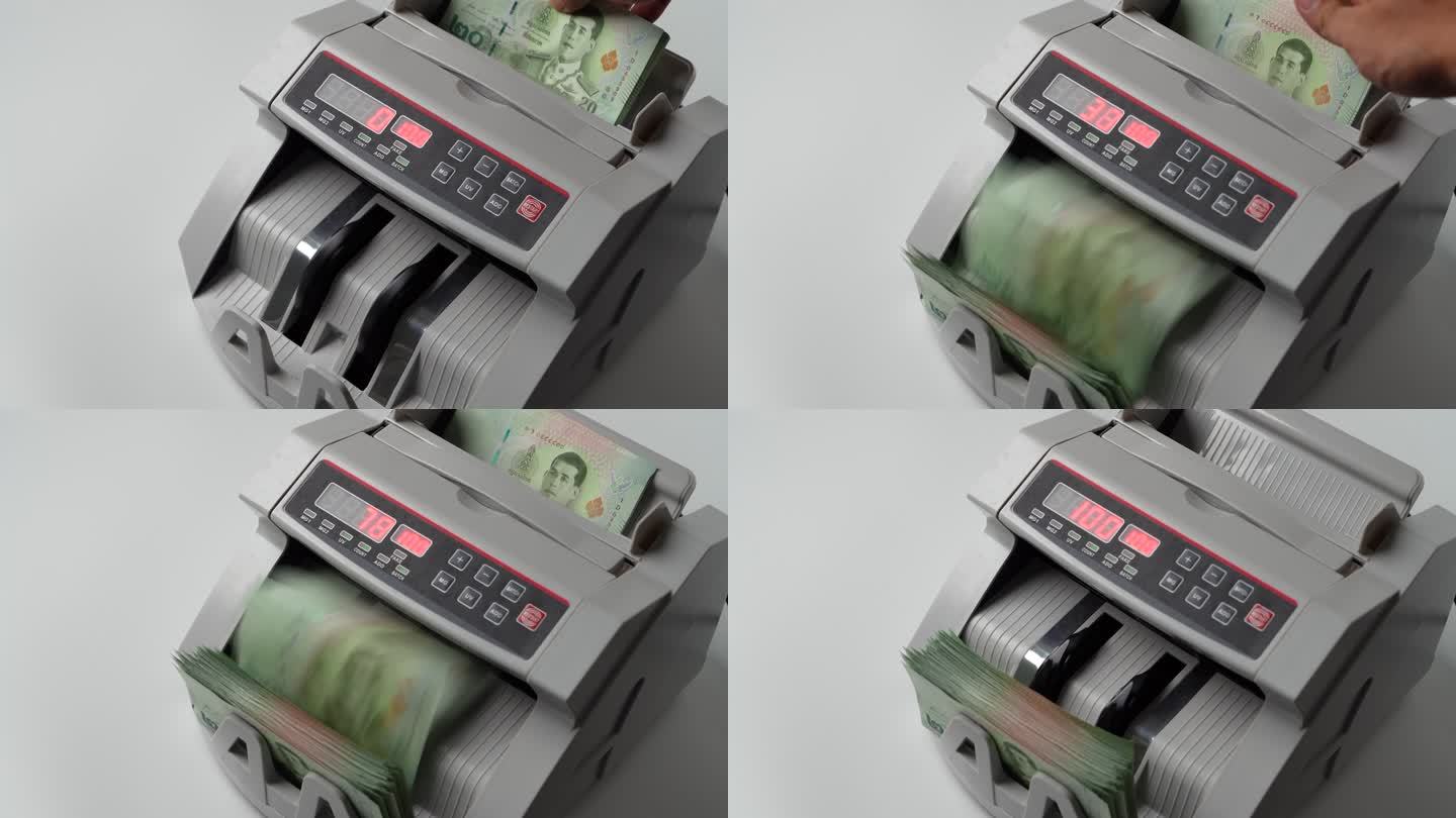 泰国银行钞票20泰铢在银行钞票计数器中计数的特写镜头，货币，计数，银行计数器，机器，纸币，金融市场概