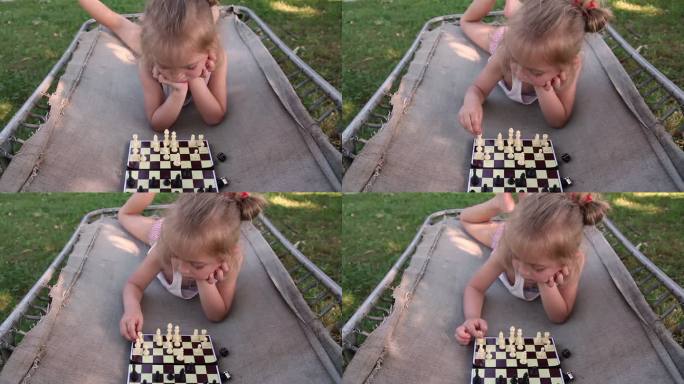 一个小女孩在露营床上下棋的特写镜头