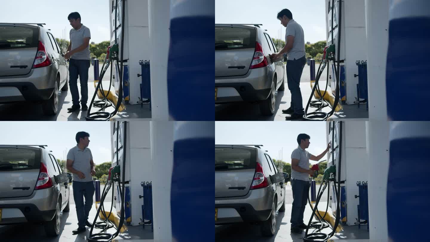 一名拉丁美洲男子在自助加油站为油箱加油