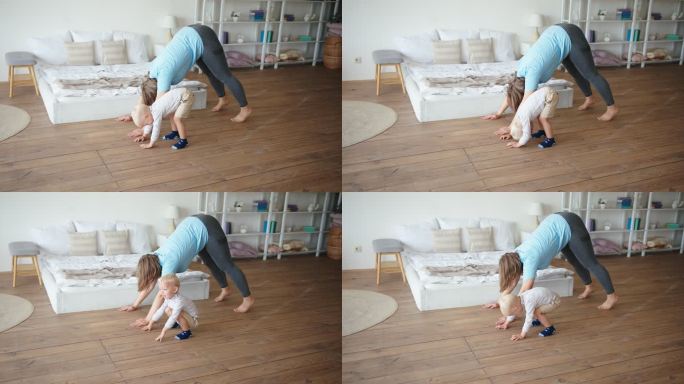 母亲和蹒跚学步的孩子一起在卧室地板上练瑜伽