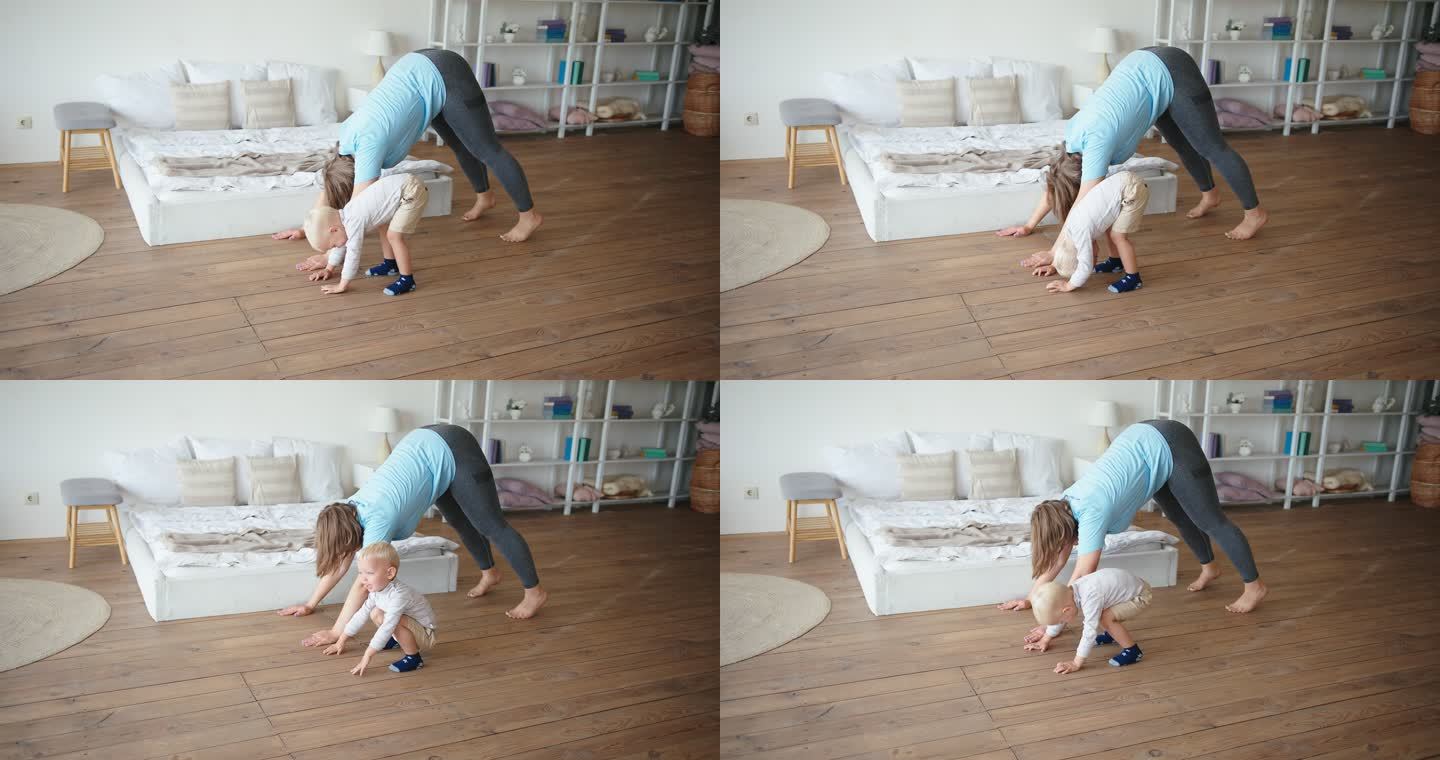 母亲和蹒跚学步的孩子一起在卧室地板上练瑜伽