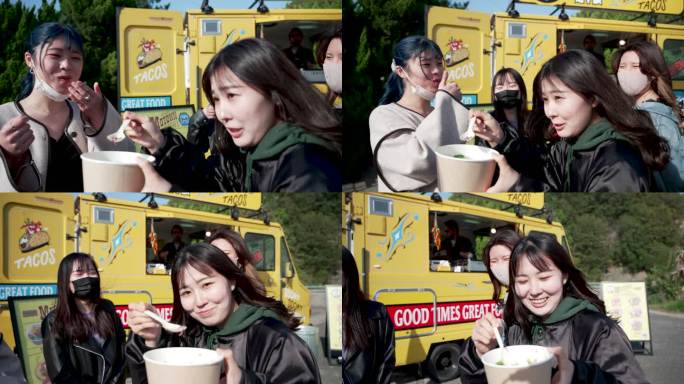 POV拍摄的年轻女性朋友在一辆餐车上分享美味小吃