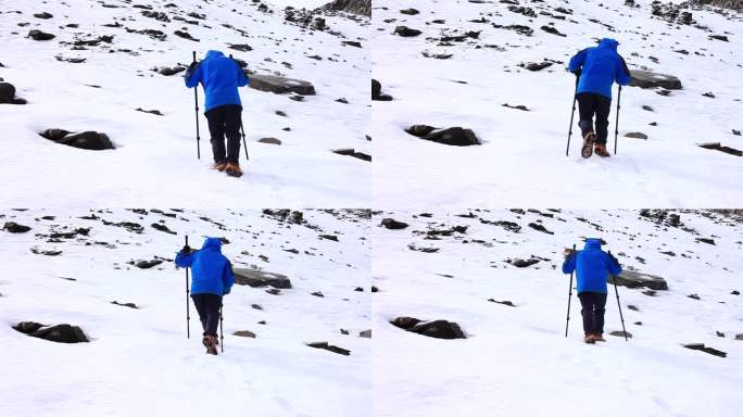 爬雪山 男子穿冲锋衣爬雪山  拄拐棍爬雪