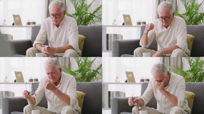 一位老人坐在沙发上，看起来在家里很紧张的4k视频片段