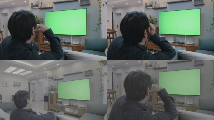 年轻人坐在沙发上看绿色屏幕电视【侵权必究