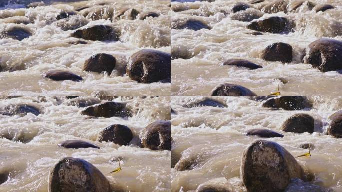 湍急的小河流水冲刷河中的石头