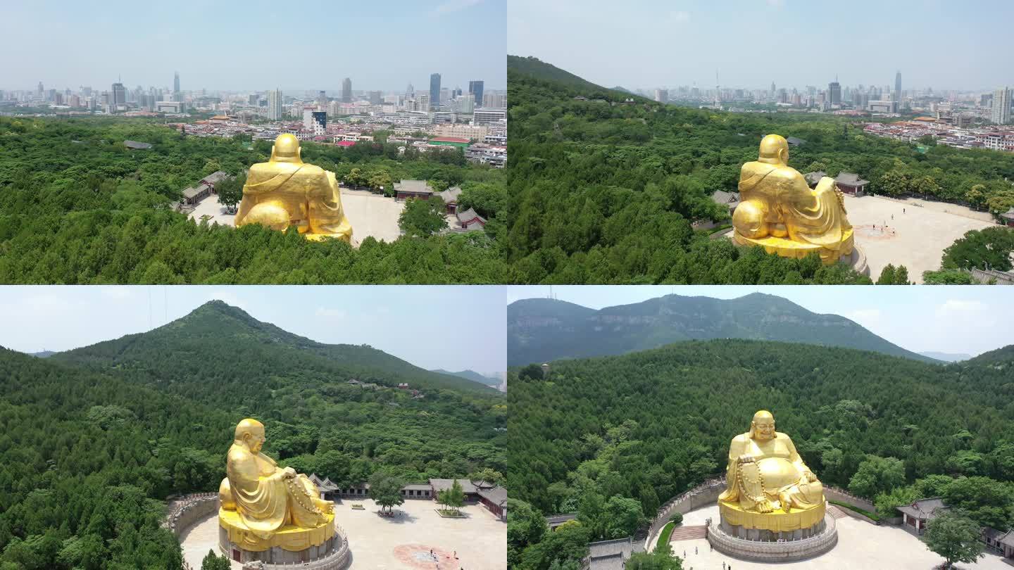 金色佛教雕像环绕山峰4k航拍