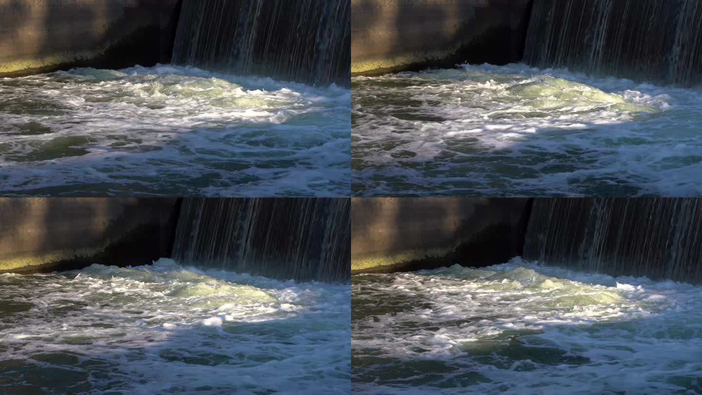 阳光照射下的湍急的水坝水流