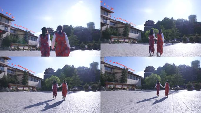在阳光下奔跑的两个少数民族藏族女孩