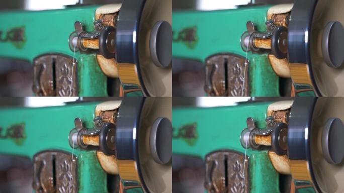 一台传统老式缝纫机在运作时的线槽特写