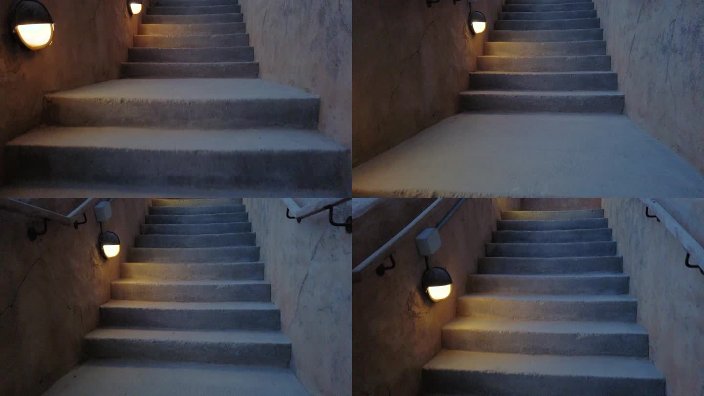 走在昏暗的楼梯上，边上有灯