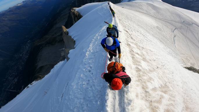 在雪坡上攀登。雄伟的欧洲阿尔卑斯山。高级登山者登山探险