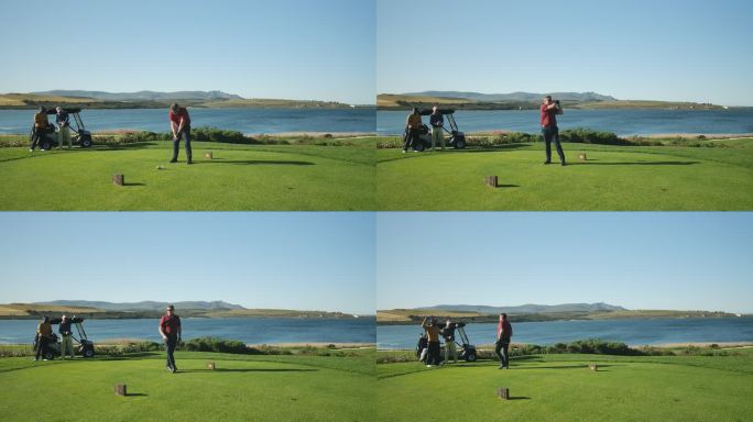 男高尔夫球手在阳光明媚的湖畔高尔夫球场发球箱上发球