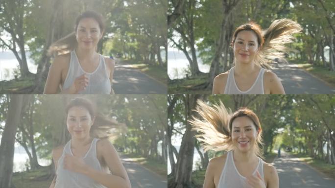 身穿运动服的强大亚洲女性在阳光明媚的早晨在公园里的大自然中跑步锻炼。年轻活跃的女性运动，慢跑锻炼运动
