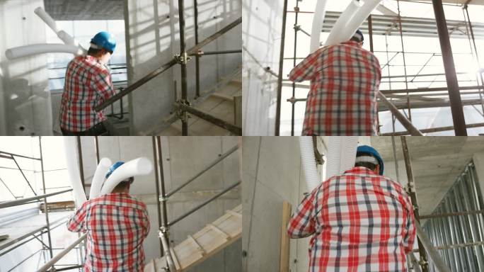 水暖工人携带波纹塑料管上施工现场的脚手架楼梯
