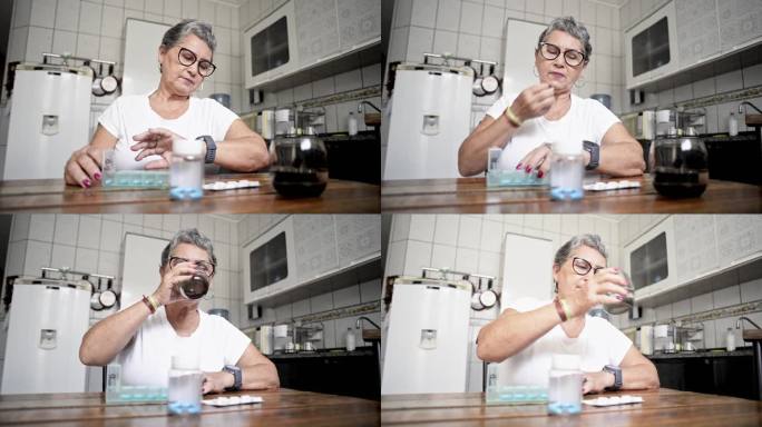 一位年长的女士看着手表，然后从每日药片组织者那里拿了一片药片，并用一口水吞下