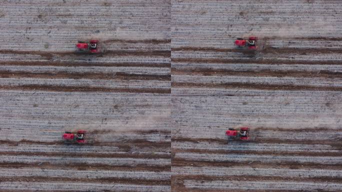 航拍农民驾驶拖拉机在田间清除地膜