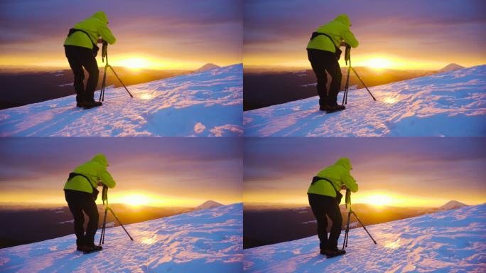 登山者在山顶拍摄单反照片