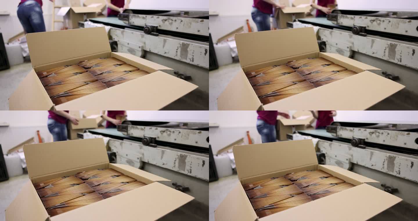 纸箱的B卷，而身份不明的工人，在印刷厂包装产品