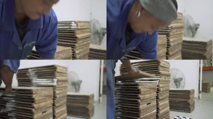 工人在工厂堆放六角形瓷砖