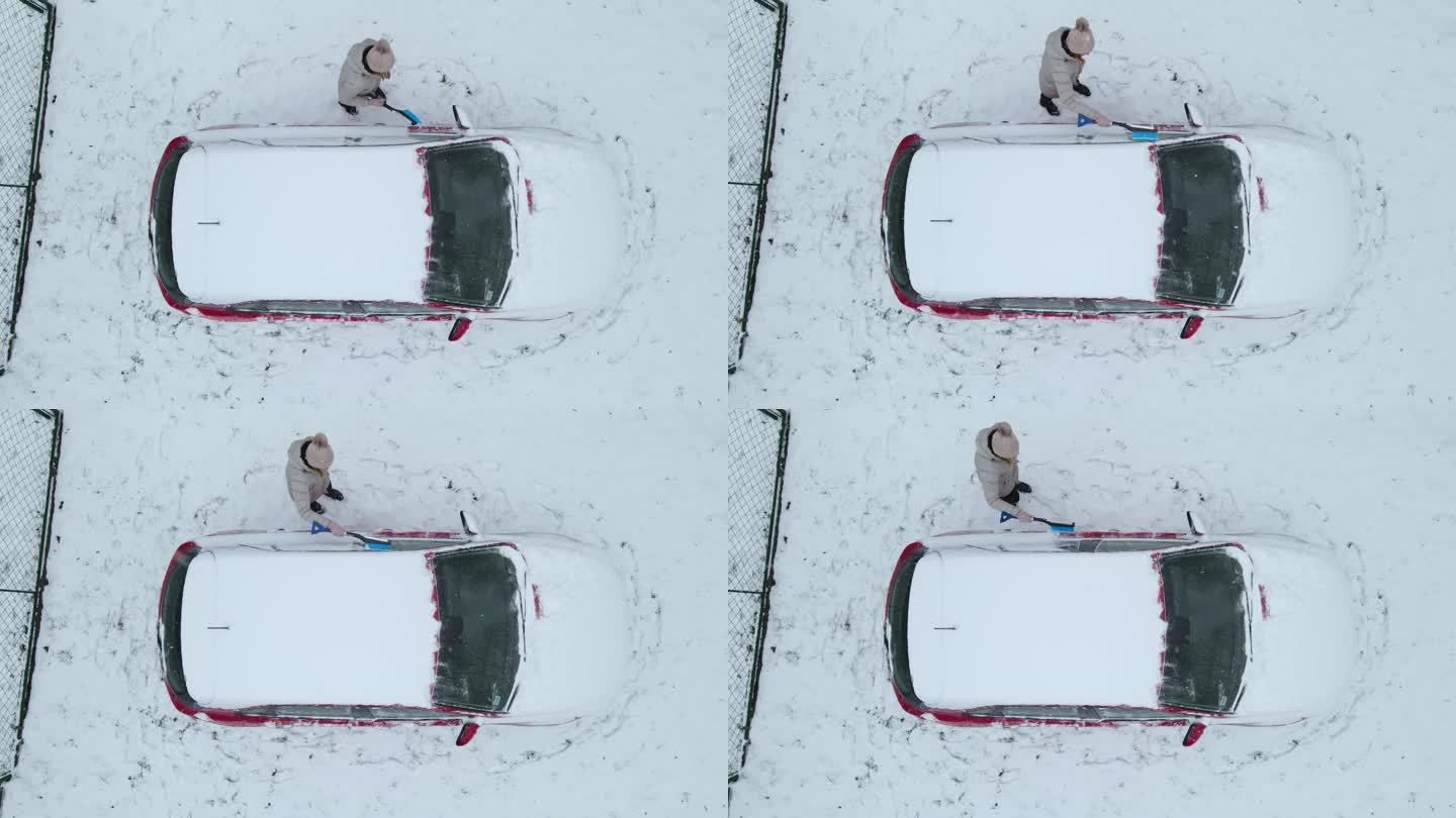 穿着冬季夹克的人从车窗上刮冰雪