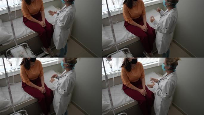 患者在医疗预约时与医生交谈-佩戴防护面罩