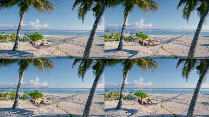 一名男子躺在沙滩上两棵棕榈树之间的吊床上