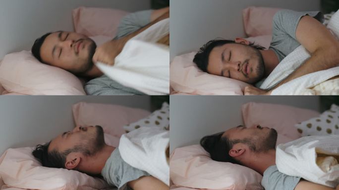 亚洲年轻男子睡眠不良，失眠躺在床上的特写镜头