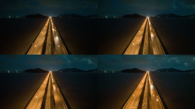 空中无人机超时差或时差夜以继日交通车在横跨松克拉湖的桥上的场景，Tinsulanonda桥。沿着横跨