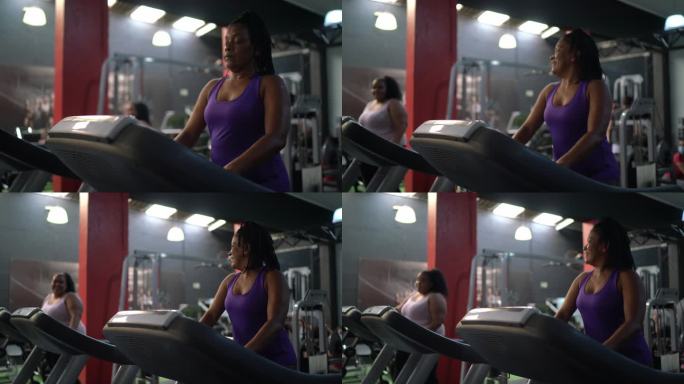 健身房里的女人在跑步机上聊天