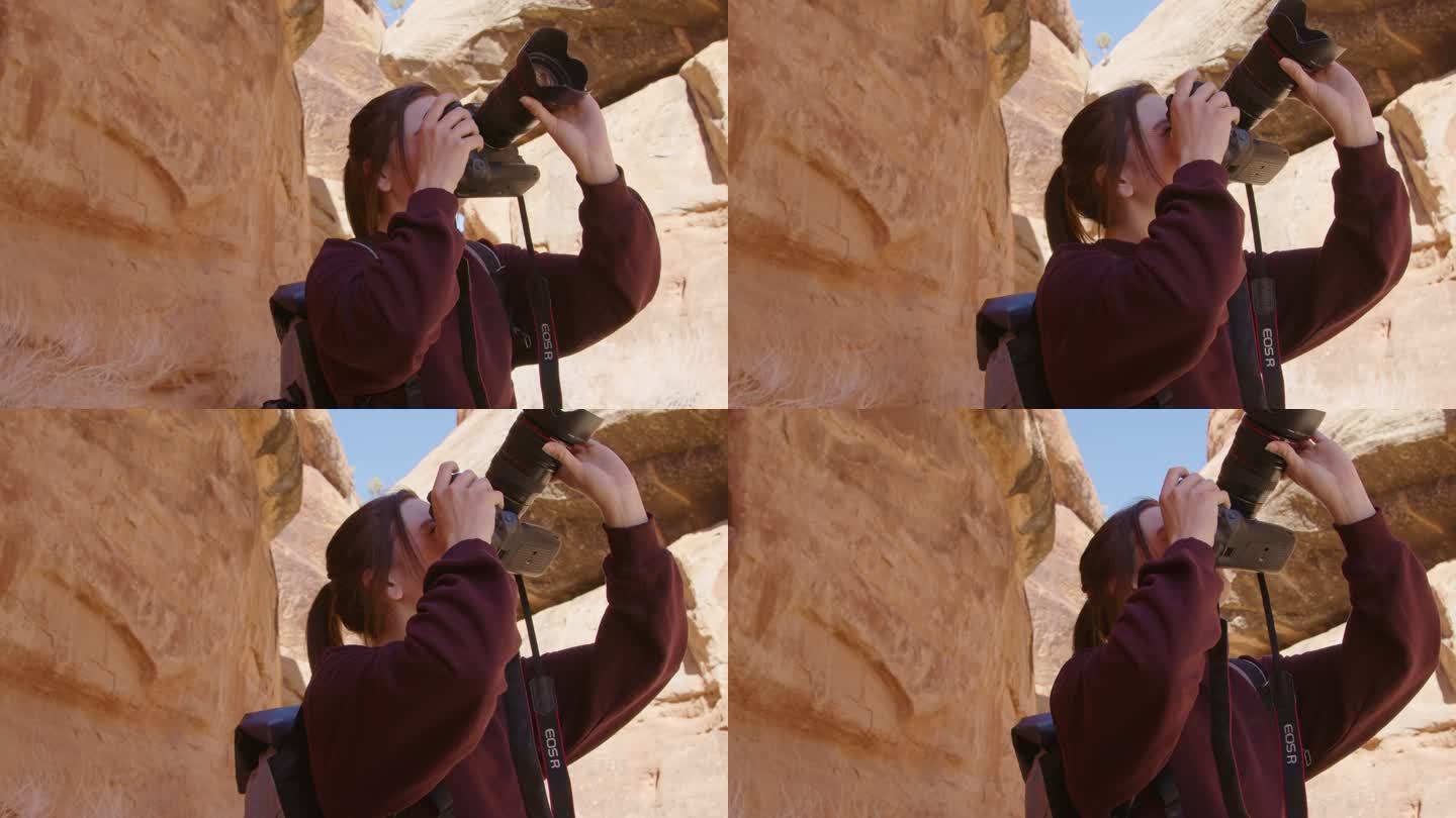 一位快乐的年轻白人女子用单反相机拍摄科罗拉多国家纪念碑内美丽风景的手持式慢镜头