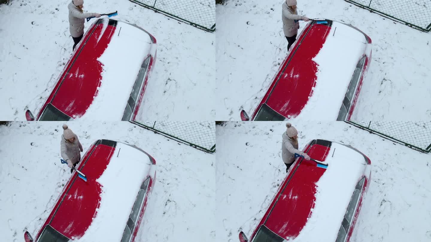一个女人在雪中清洗她的车