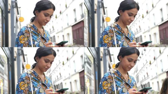 美丽时尚的女人在老城区，使用智能手机-蒙马特，巴黎