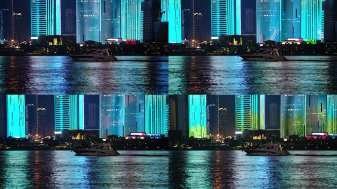 游艇航行驶过城市夜景