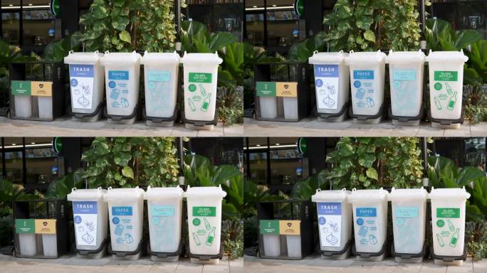 不同种类的垃圾桶放在公共场所前。
