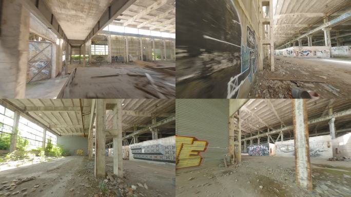 废弃的仓库，墙壁被毁坏。FPV无人机探索大厅内部