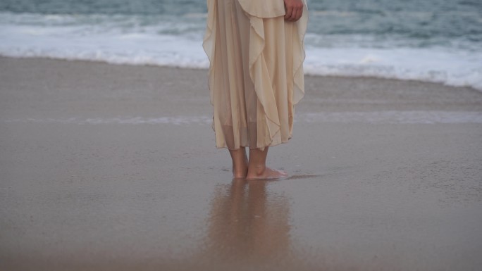 美女站在海边沙滩海水冲刷脚丫裙子海滩浪花
