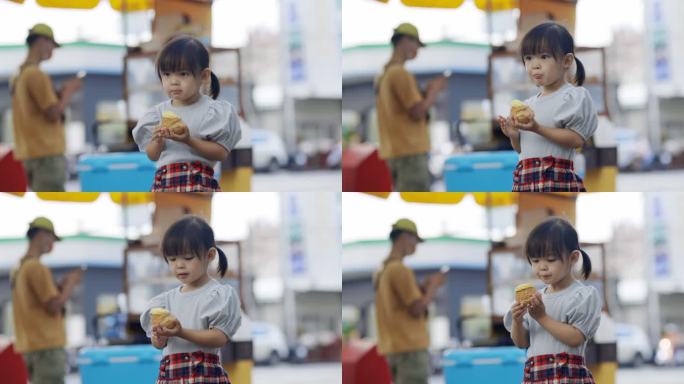 小女孩很喜欢吃奶油泡芙