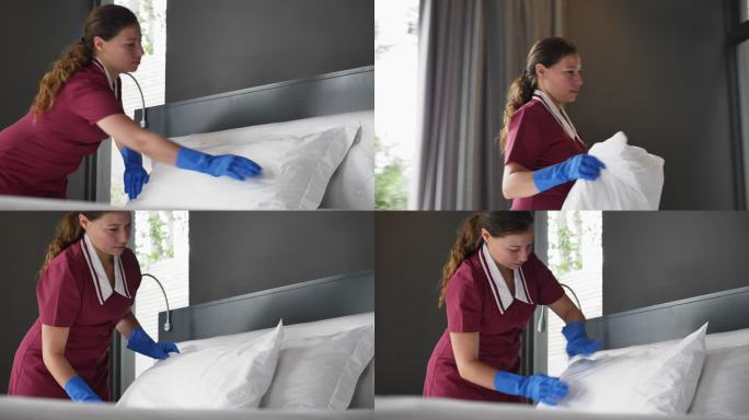 女酒店女佣戴着手套在酒店房间整理床铺