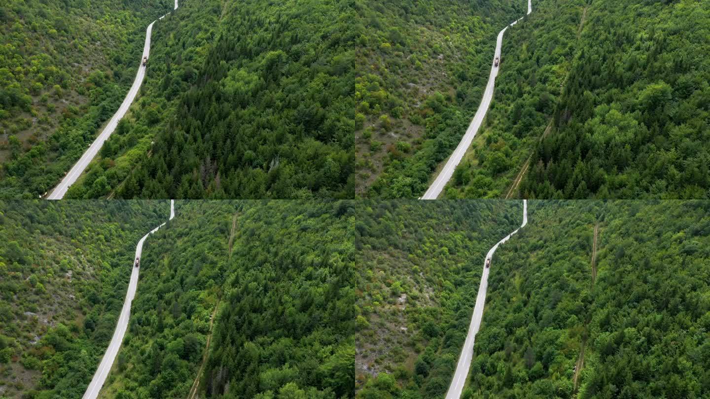 卡车正在运输树干盘山公路绿水青山火车行驶