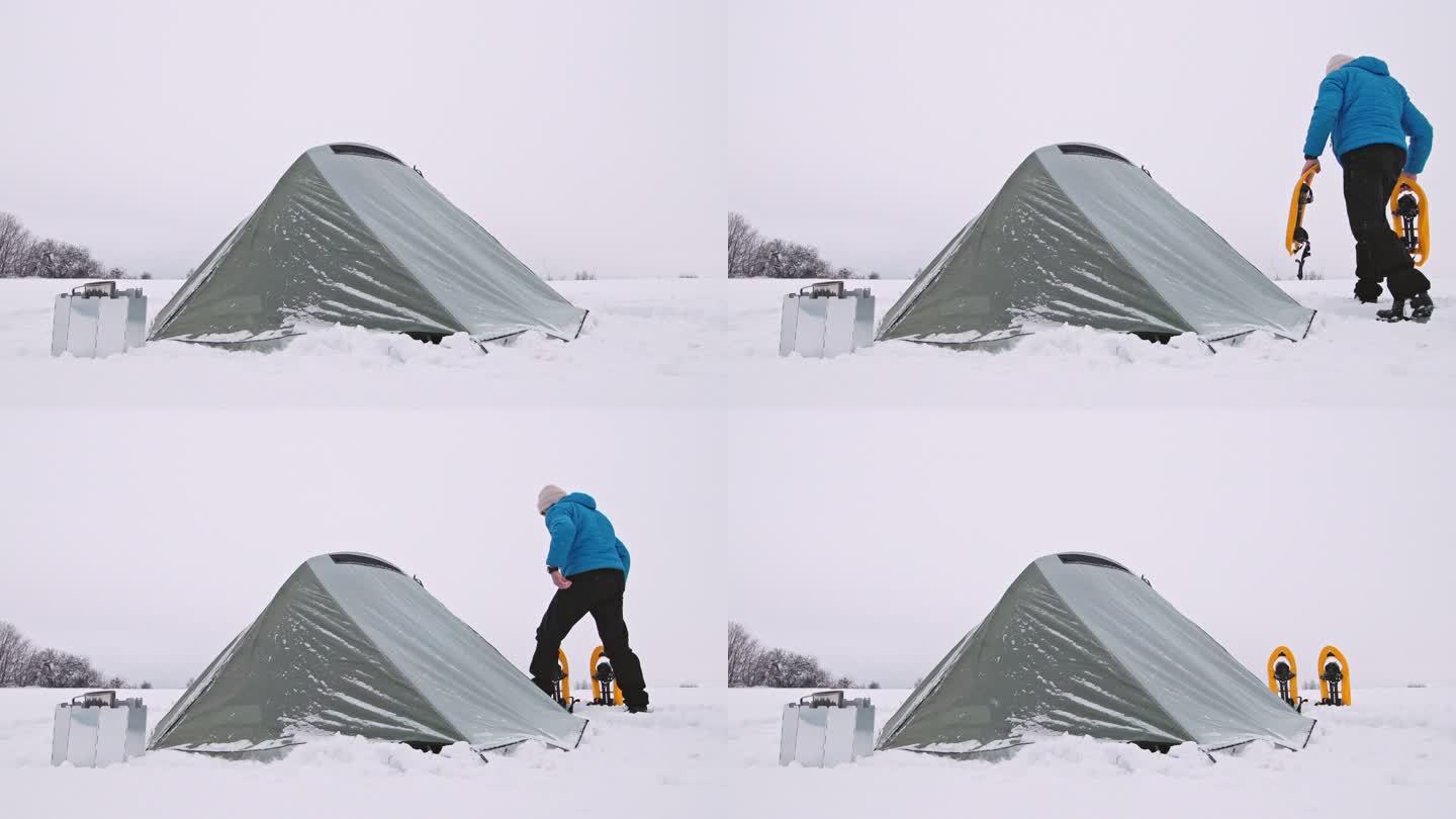 成熟的旅游帐篷露营在冬季山区独自在大自然中。