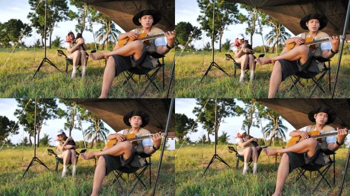 在帐篷前一起弹吉他和唱歌。露营