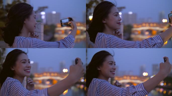 美女在成都旅游傍晚锦江边用手机拍照
