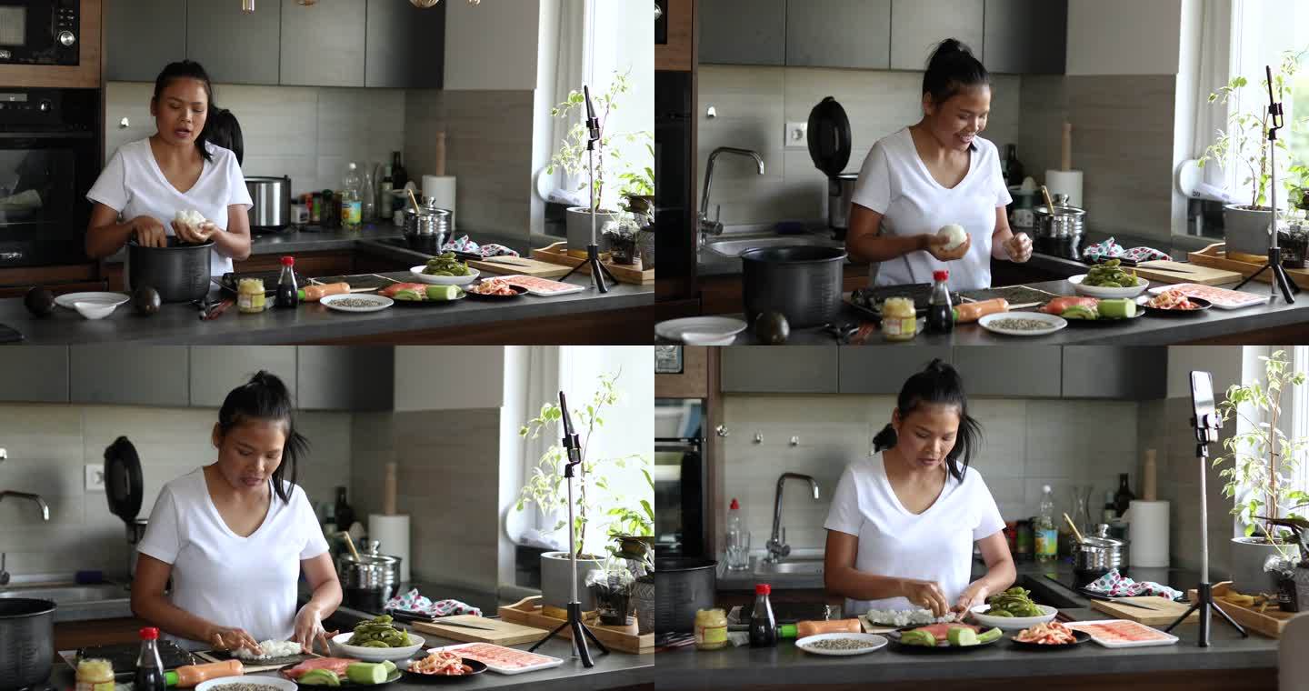 熟练的女人，用手机和三脚架为她的食物频道录制寿司制作过程
